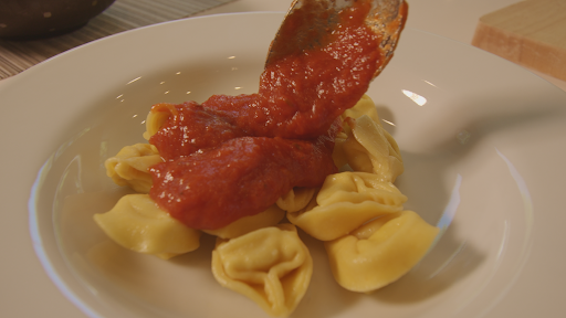 Plated tortellini with tomato sauce.